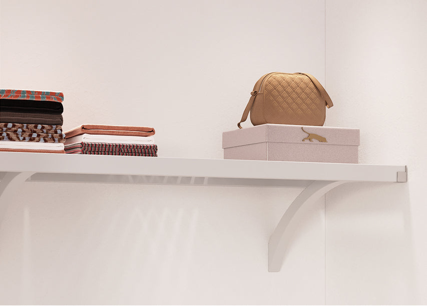 with shelf in closet with items stored on shelf